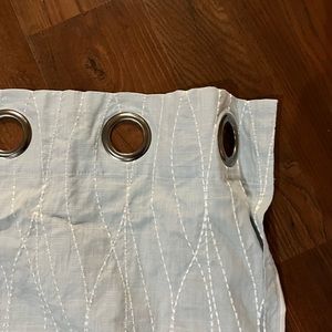 Blue linen curtains with white stitching